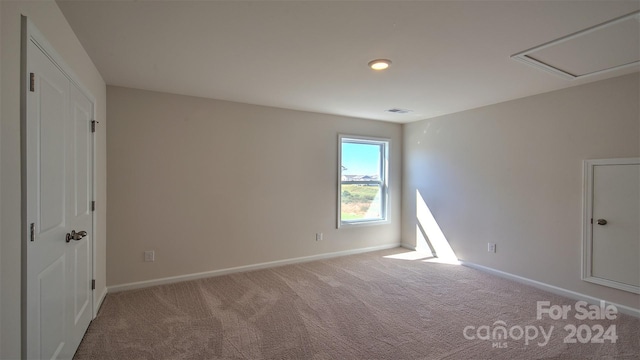 unfurnished bedroom with carpet, visible vents, and baseboards