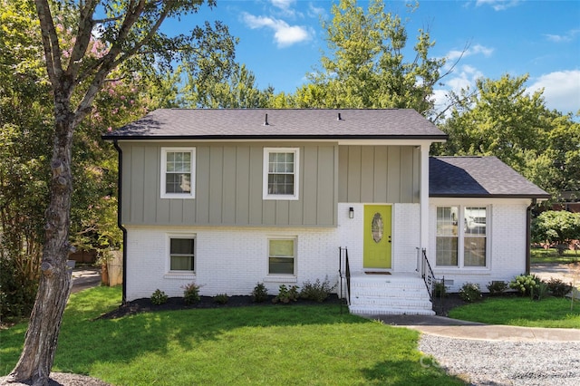 raised ranch with a front yard