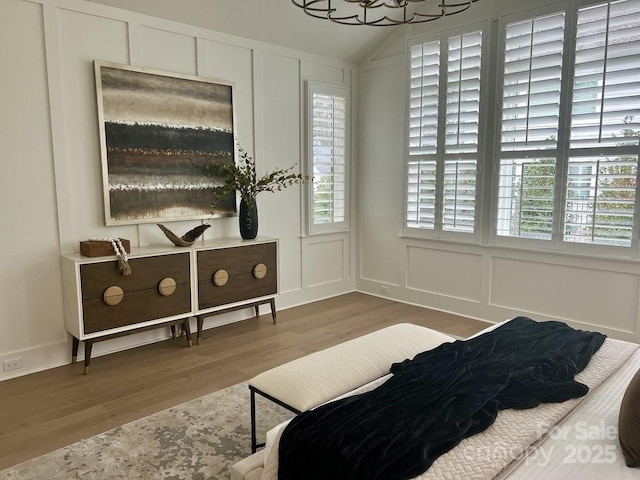 bedroom featuring hardwood / wood-style floors and vaulted ceiling