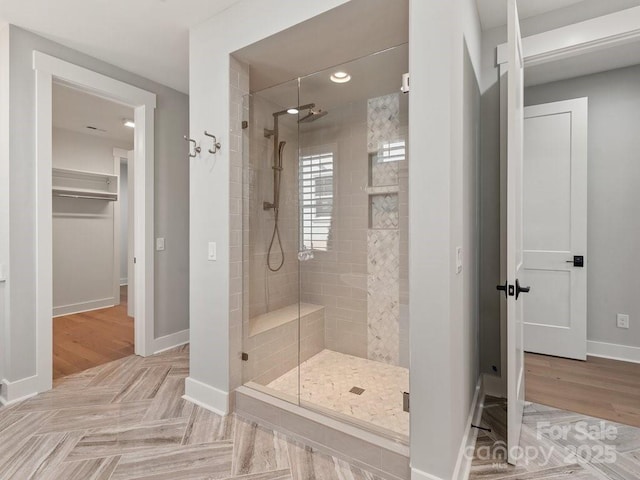 bathroom featuring hardwood / wood-style flooring and walk in shower