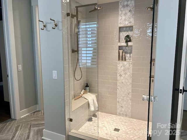 bathroom with a shower with door