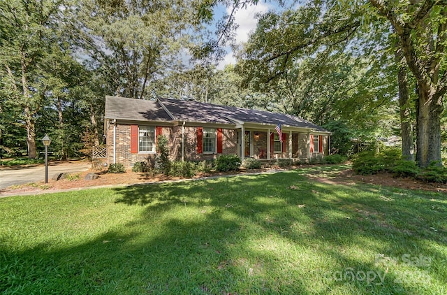 single story home with a front yard and a porch