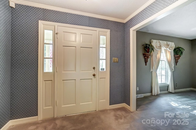 entrance foyer with crown molding and carpet flooring