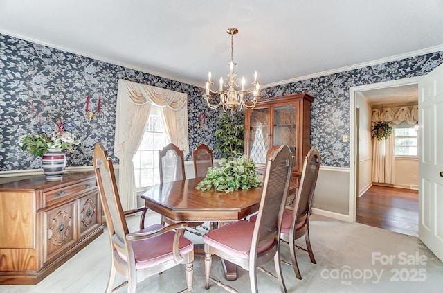 dining area with an inviting chandelier, crown molding, and light carpet