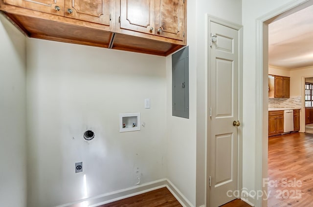 laundry room with hardwood / wood-style floors, cabinets, electric panel, hookup for a washing machine, and electric dryer hookup