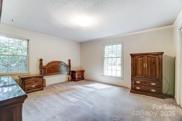 carpeted bedroom featuring a textured ceiling