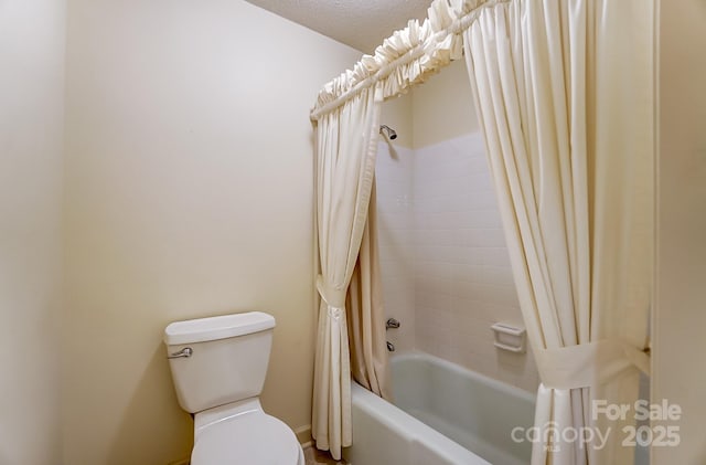 bathroom featuring shower / bath combo and toilet