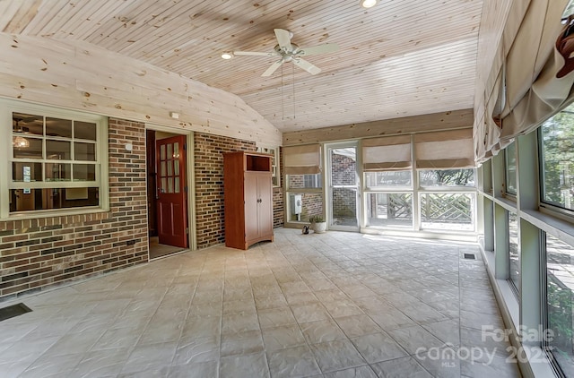 unfurnished sunroom featuring ceiling fan, vaulted ceiling, and wooden ceiling