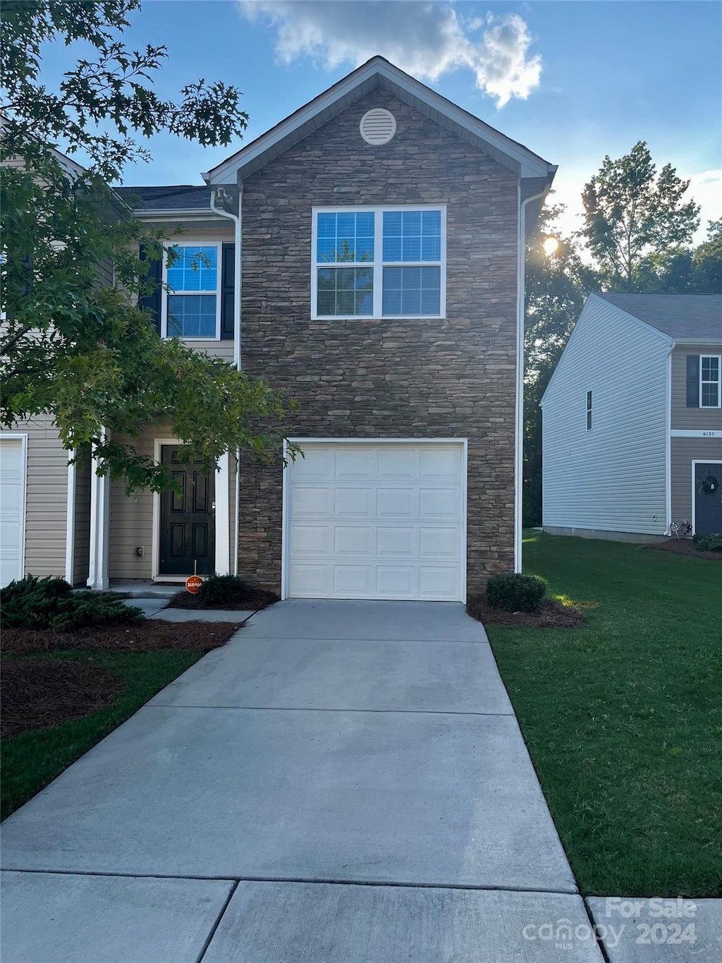 front facade featuring a yard and a garage