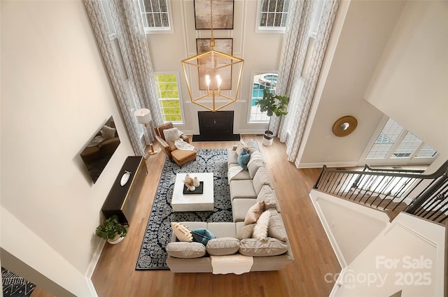 living room featuring hardwood / wood-style flooring and a high ceiling