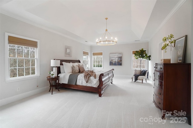 bedroom with crown molding, light colored carpet, a notable chandelier, and a tray ceiling