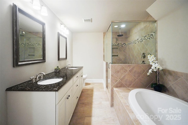 full bathroom with vanity, shower with separate bathtub, and toilet