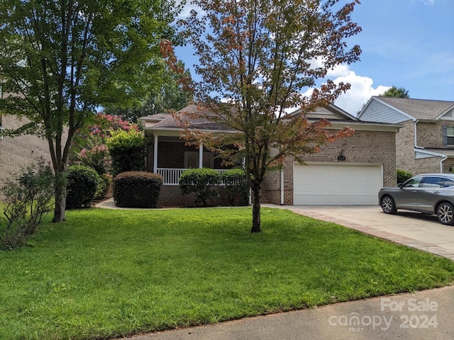 view of front of home with a garage and a front yard