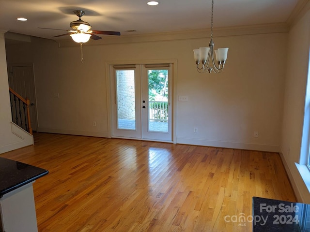 interior space featuring french doors, ornamental molding, ceiling fan with notable chandelier, and light hardwood / wood-style floors