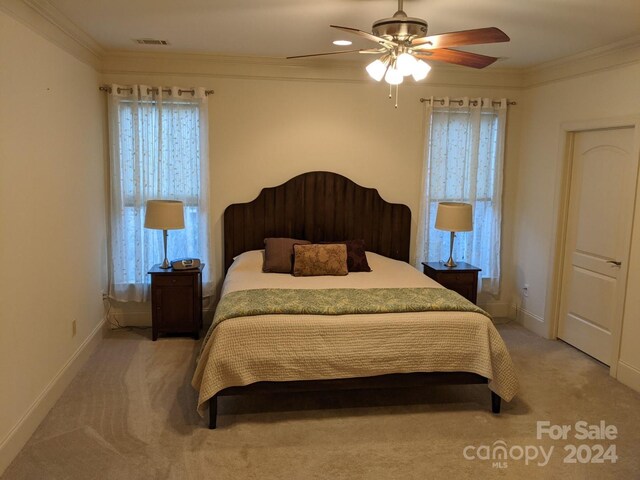 bedroom featuring ornamental molding, ceiling fan, and carpet flooring