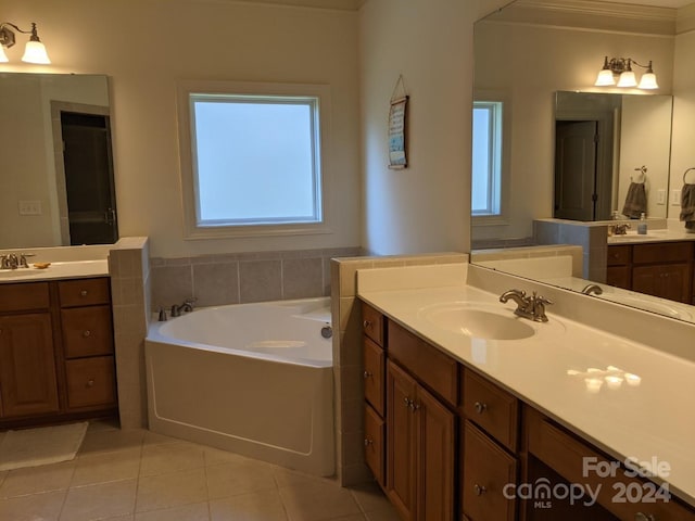 bathroom featuring vanity, tile patterned flooring, and a washtub