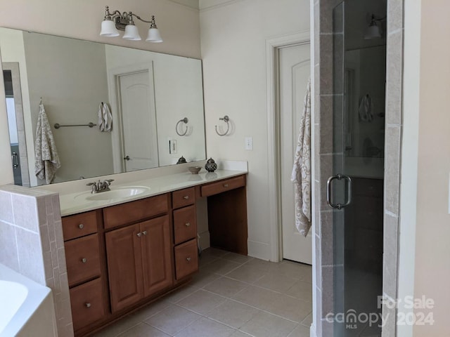 bathroom with vanity, a shower with shower door, and tile patterned flooring