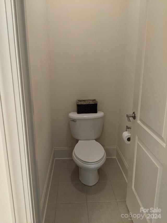 bathroom featuring tile patterned flooring and toilet