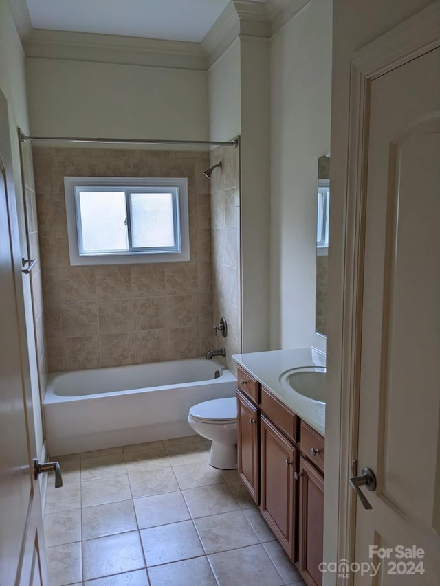 full bathroom with crown molding, tiled shower / bath combo, vanity, tile patterned floors, and toilet