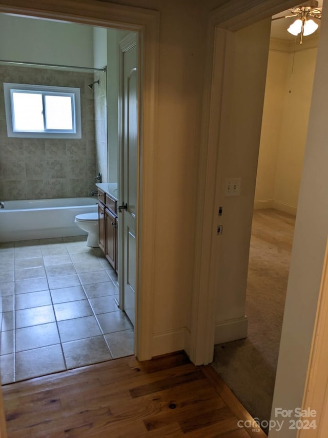 full bathroom featuring a bidet, vanity, tiled shower / bath, tile patterned floors, and toilet