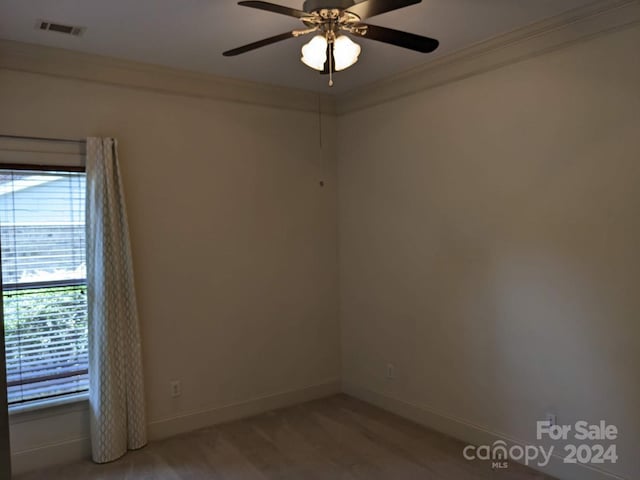 carpeted spare room with ornamental molding and ceiling fan