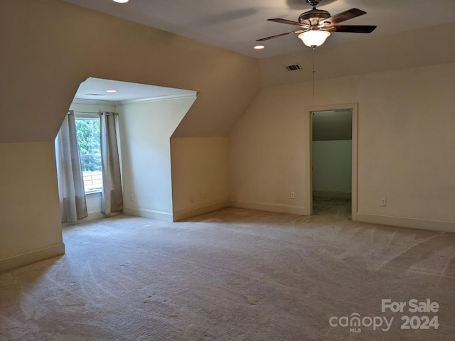 bonus room with ceiling fan, light colored carpet, and lofted ceiling