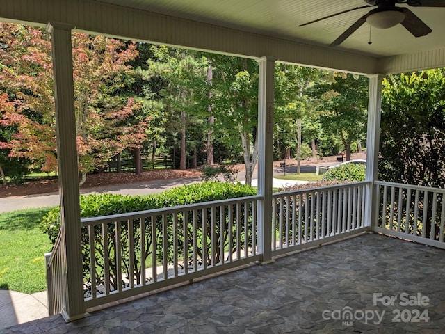 view of patio featuring ceiling fan and a porch