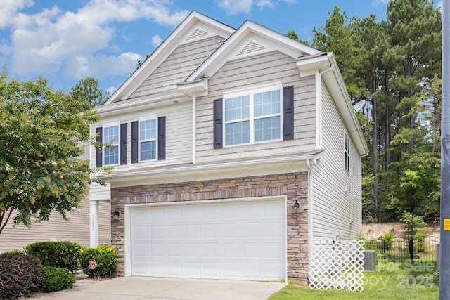 view of front of property with a garage and central AC unit