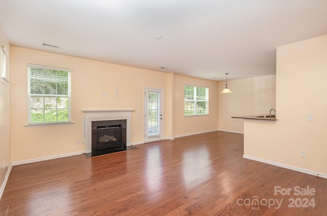 unfurnished living room featuring dark hardwood / wood-style flooring