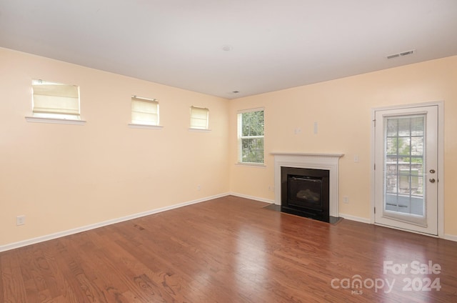 unfurnished living room featuring wood-type flooring