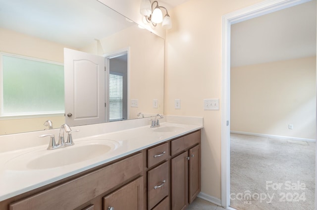 bathroom featuring dual vanity and a chandelier