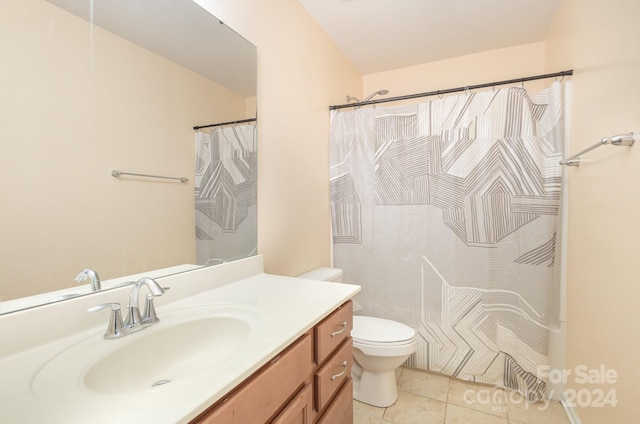 bathroom with vanity, toilet, and tile patterned floors