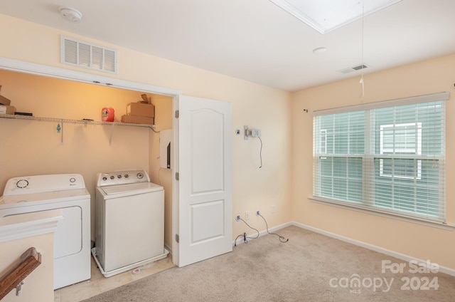 laundry area featuring light carpet and washing machine and dryer