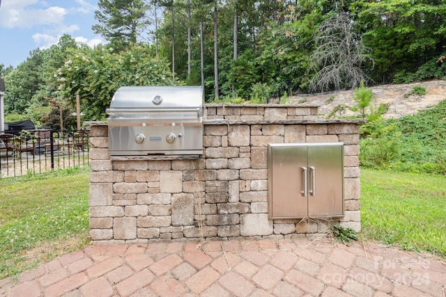 view of patio with area for grilling and exterior kitchen