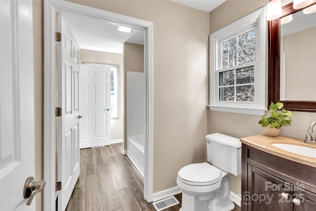 bathroom with vanity, hardwood / wood-style floors, and toilet