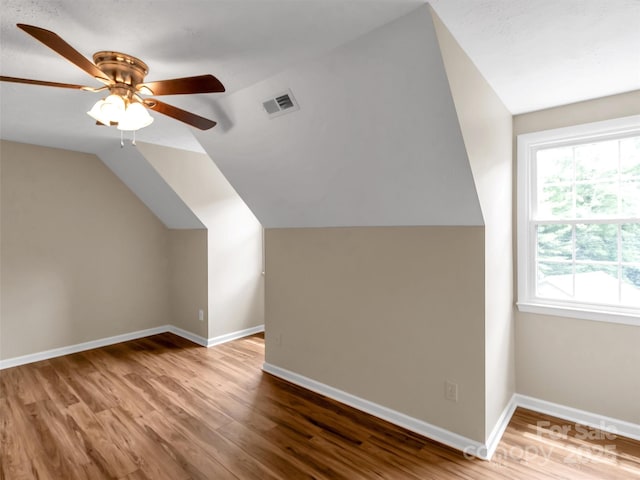 bonus room with lofted ceiling, hardwood / wood-style flooring, and ceiling fan