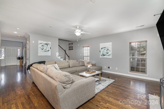 living room featuring a wealth of natural light, dark wood-type flooring, and ceiling fan