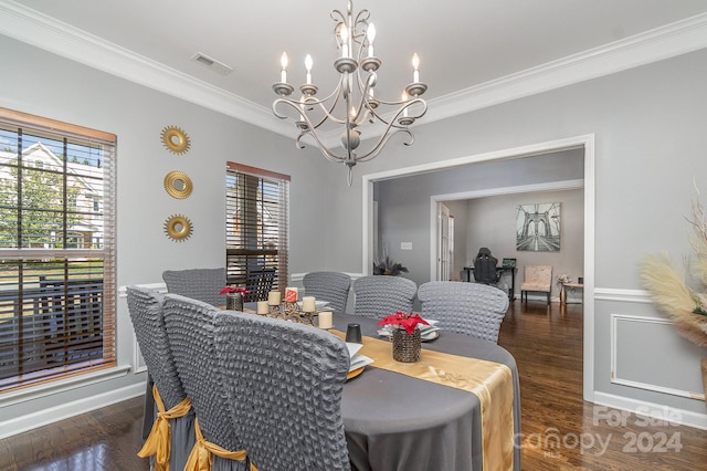 dining room featuring ornamental molding, an inviting chandelier, and dark hardwood / wood-style floors