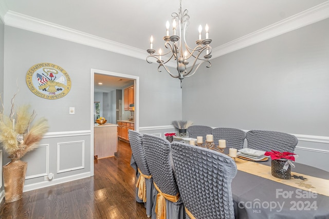 dining room with crown molding, dark hardwood / wood-style floors, and a chandelier