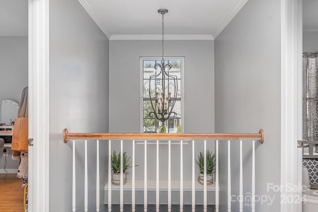 details with ornamental molding and an inviting chandelier