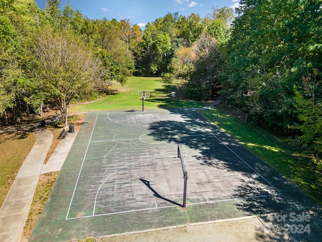 view of sport court with a yard