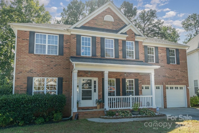 view of front of property featuring covered porch and a garage