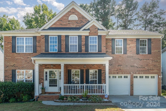 view of front of property with covered porch and a garage