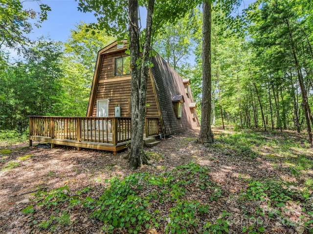 view of home's exterior featuring a wooden deck