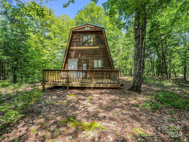 rear view of property featuring a wooden deck