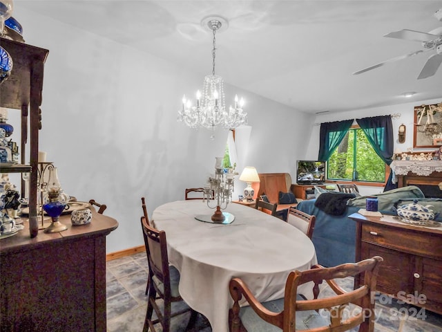 dining space with ceiling fan with notable chandelier