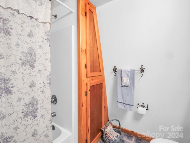 bathroom with toilet and shower / bathtub combination with curtain