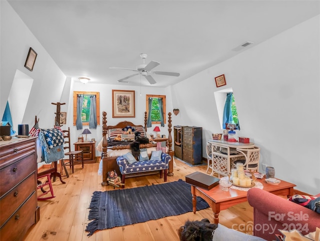 bedroom featuring light wood-type flooring, ceiling fan, and multiple windows