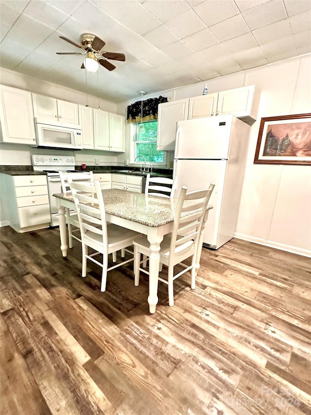 kitchen with ceiling fan, sink, white appliances, light wood-type flooring, and white cabinets