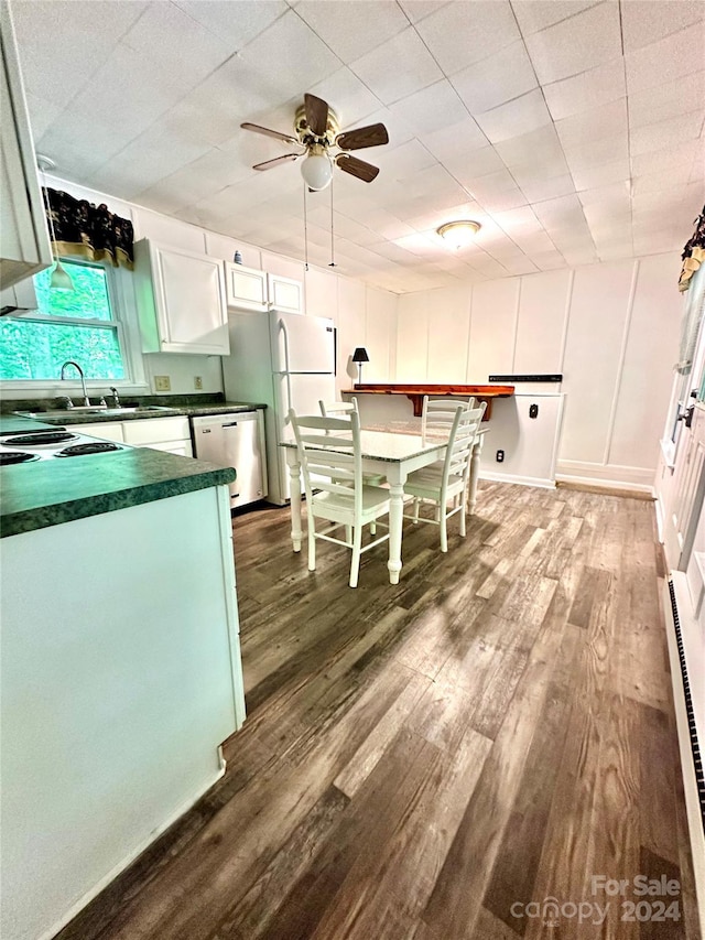 kitchen with dishwasher, sink, dark wood-type flooring, white cabinets, and white refrigerator